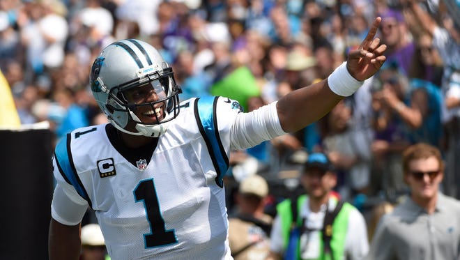 Carolina Panthers quarterback Cam Newton (1) reacts after scoring a touchdown in the first quarter at Bank of America Stadium.