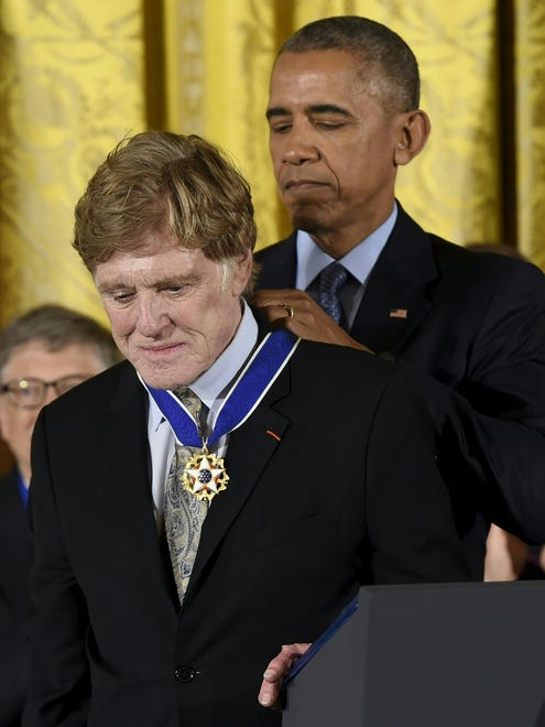 President Barack Obama presents actor and director Robert Redford with the Presidential Medal of Freedom.