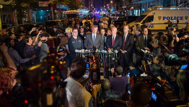 Mayor Bill de Blasio, center, and NYPD Chief of Department James O'Neill, center right, speak during a press conference near the scene of an apparent explosion on West 23rd street in Manhattan's Chelsea neighborhood, in New York, Saturday, Sept. 17, 2016. Police say more than two dozen people were injured in the explosion Saturday night. (AP Photo/Andres Kudacki) ORG XMIT: NYAK104