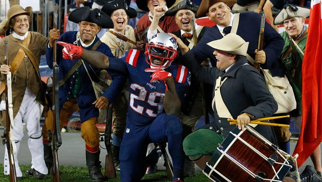 New England Patriots running back LeGarrette Blount (29) celebrates his touchdown run against the Houston Texans with the End Zone Militia during the second half at Gillette Stadium.