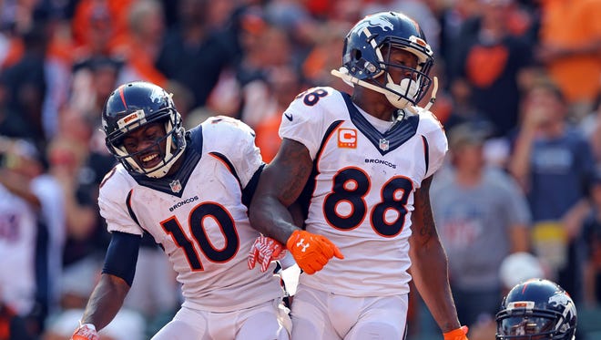 Broncos receiver Demaryius Thomas (88) celebrates his touchdown catch with Emmanuel Sanders (10) during the second half against the Bengals.