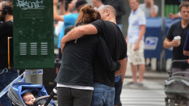 A couple embraces as they visit the scene of an explosion on West 23rd Street on Sept. 18, 2016, in New York City.
