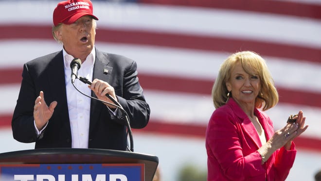 Former Arizona Gov. Jan Brewer applauds as Donald Trump speaks during a March 19 campaign rally in Fountain Hills.