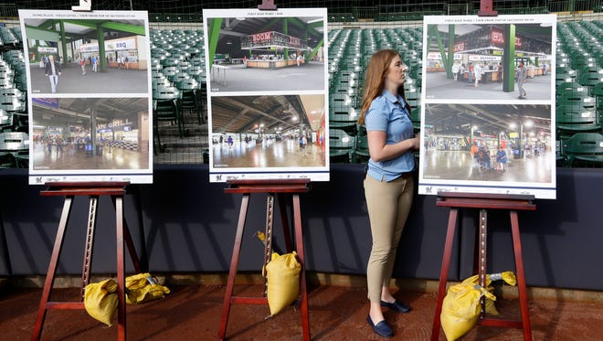 Jacque Lefeber, a manager of special events, adjusts the renderings before the press conference.