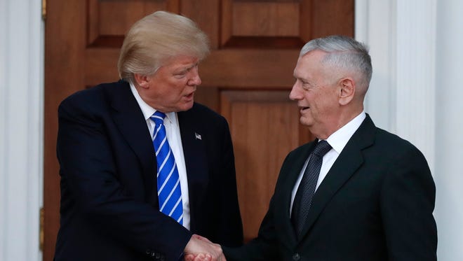 In this Nov. 19, 2016, file photo, President-elect Donald Trump shakes hands with retired Marine general James Mattis as he leaves Trump National Golf Club Bedminster clubhouse in Bedminster, N.J.
