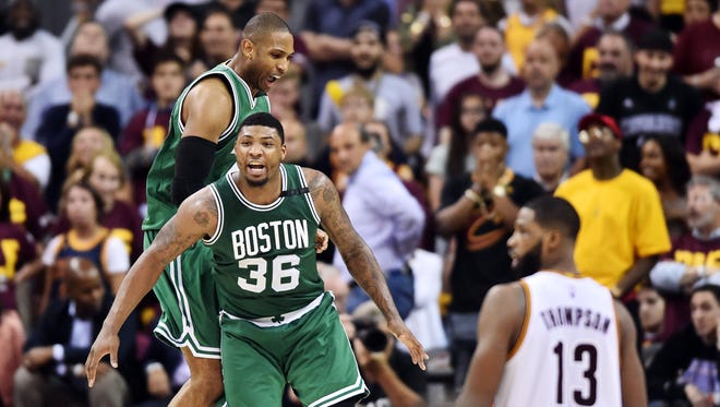 Boston Celtics guard Marcus Smart (36) and center Al Horford (42) celebrate after the Celtics beat the Cleveland Cavaliers in Game 3 of the Eastern Conference finals.