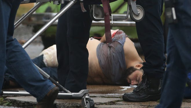 Ahmad Khan Rahami is taken into custody after a shootout with police in Linden, N.J.