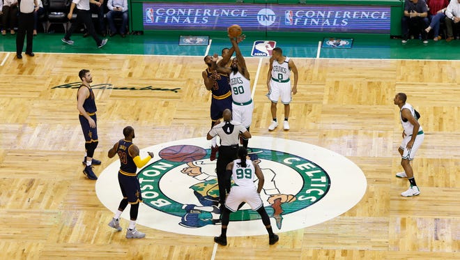 Cleveland Cavaliers forward Tristan Thompson and Boston Celtics forward Amir Johnson battle for the tip off during the first quarter in game one of the Eastern Conference finals.