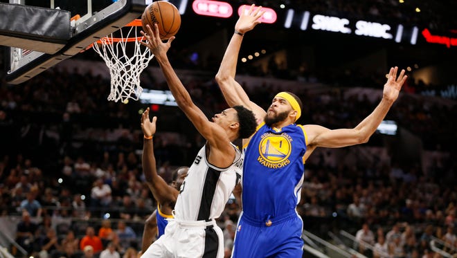 San Antonio Spurs point guard Dejounte Murray drives to the basket as Golden State Warriors center JaVale McGee defends during the first half in Game 4 of the Western Conference finals.