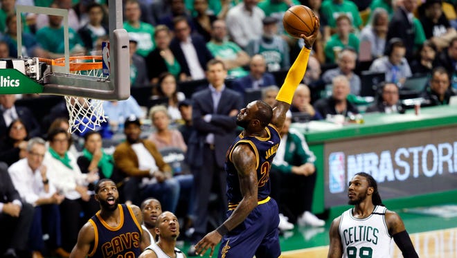 LeBron James dunks against the Boston Celtics during the third quarter of Game 5 of the Eastern Conference finals.
