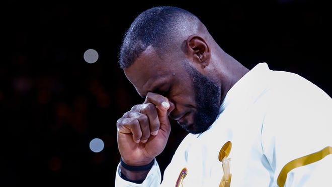 LeBron James fights back tears during the Cavs' ring ceremony on opening night at Quicken Loans Arena.