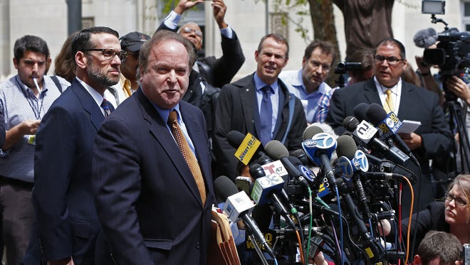 Attorney Alan Zegas reads a statement to the media as David Wildstein listens in after his first appearance at Martin Luther King Jr. Federal Courthouse in Newark, N.J. Friday, May 1, 2015. Wildstein pleaded guilty Friday to helping engineer traffic jams at the George Washington Bridge in a political payback scheme he said also involved two other Chris Christie loyalists. But he did not publicly implicate Christie himself.  (AP Photo/Rich Schultz)