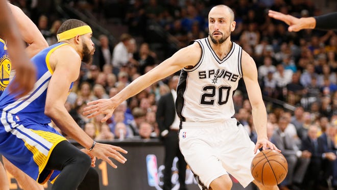 San Antonio Spurs shooting guard Manu Ginobili drives to the basket as Golden State Warriors center JaVale McGee defends during the first half in Game 4 of the Western Conference finals.