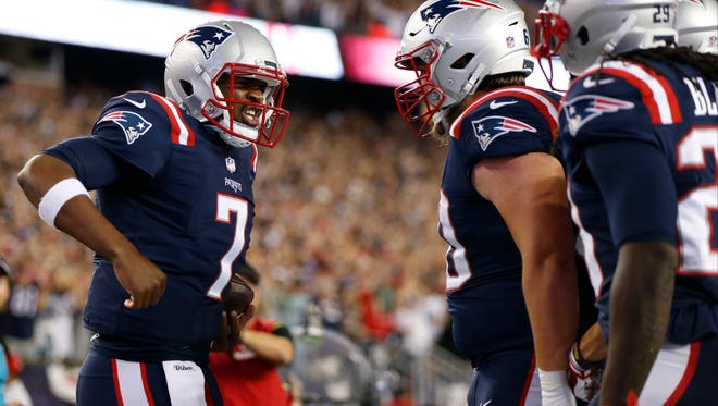 New England Patriots quarterback Jacoby Brissett (7) celebrates with team mates after rushing for a touchdown during the first quarter against the Houston Texans at Gillette Stadium.