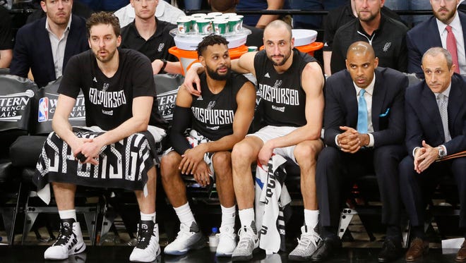 San Antonio Spurs players (from left to right) Pau Gasol (16) Patty Mills (8) and Manu Ginobili (20) watch on the bench during the second half in Game 4 of the Western Conference finals.