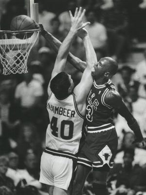 Michael Jordan slams home two over Pistons center Bill Laimbeer.