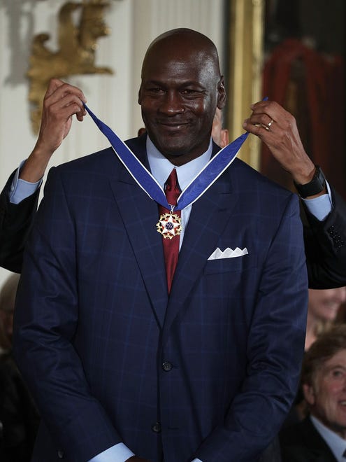 President Barack Obama presents the Presidential Medal of Freedom to former NBA star Michael Jordan.