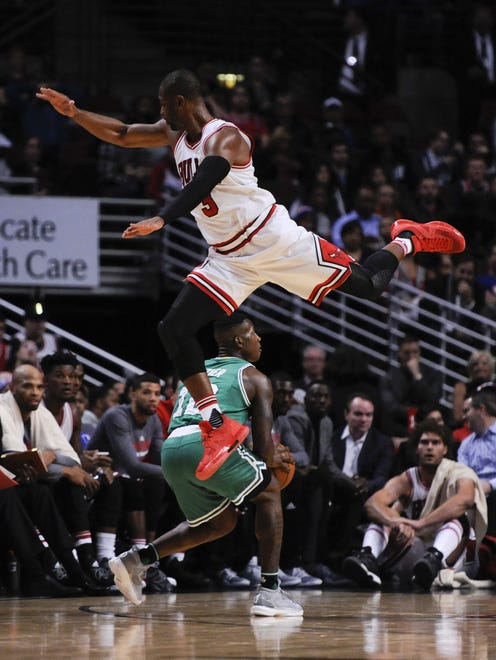 Dwyane Wade leaps over Terry Rozier.