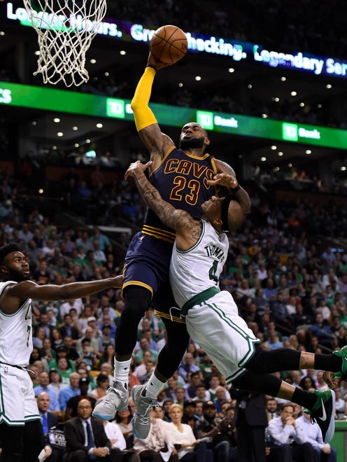 Boston Celtics guard Isaiah Thomas (4) fouls Cleveland Cavaliers forward LeBron James (23) during the second half in game one of the Eastern conference finals of the NBA Playoffs at TD Garden.