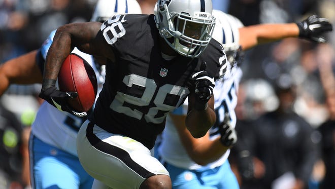 Oakland Raiders running back Latavius Murray (28) carries the ball to score a touchdown during the first half against the Tennessee Titans at Nissan Stadium.