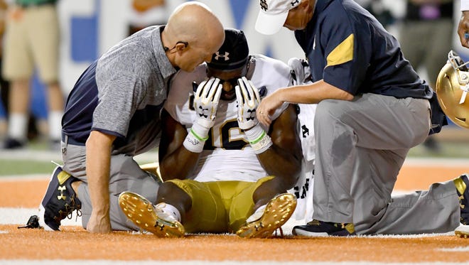 Notre Dame Fighting Irish wide receiver Torii Hunter Jr. is tended to by medical staff after a hard hit in the third quarter against  Texas. No targeting was called, but the hit certainly was controversial.