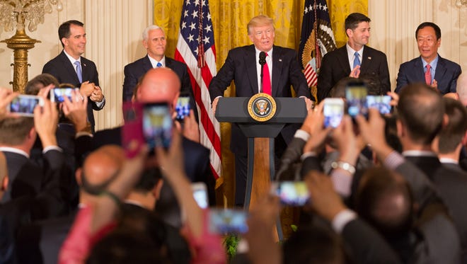 President Donald J. Trump (center) delivers remarks during the Jobs Announcement event with Foxconn  Wednesday, July 26, 2017, in the East Room of the White House in Washington, D.C. With him (from left) Wisconsin Governor Scott Walker, is Vice President Mike Pence , U..S. Representative Paul Ryan, and Foxconn Technology Group Chairman Terry Gou. (Official White House Photo by Shealah Craighead)