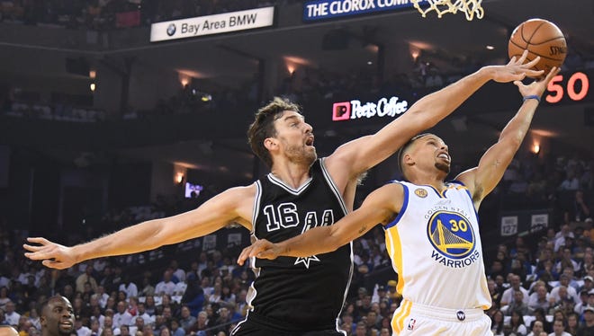 Stephen Curry goes up for a layup over the outstretched arms of Pau Gasol.