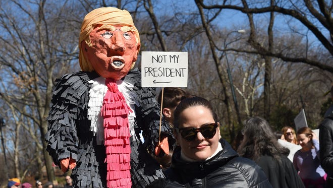 A protestors carries a Donald Trump pinata during the New York 'Not My President's Day' rally on Feb. 20, 2017.