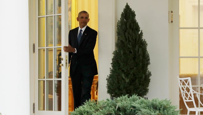 President Obama leaves the Oval Office of the White House in Washington Friday before the start of presidential inaugural festivities for the incoming 45th President of the United States Donald Trump.