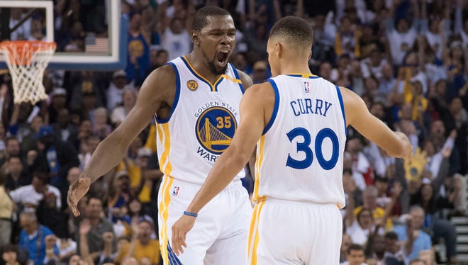 Kevin Durant celebrates with Stephen Curry.