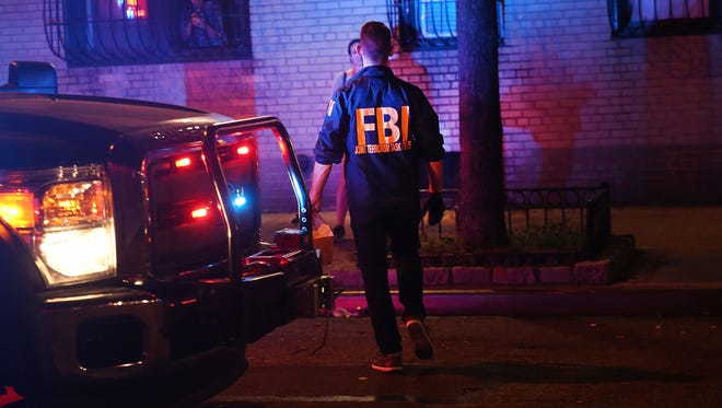 Members of the FBI search an area for evidence as police, firefighters and emergency workers gather at the scene of an explosion in Manhattan on September 17, 2016 in New York City.