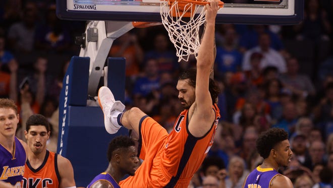 Oklahoma City Thunder center Steven Adams (12) dunks the ball against the Los Angeles Lakers during the second quarter at Chesapeake Energy Arena.