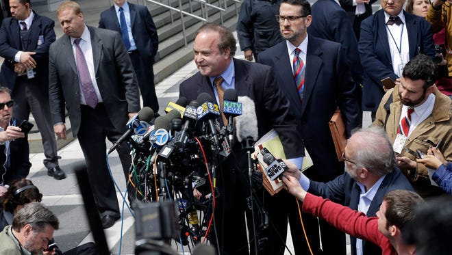David Wildstein, center right, listens as his attorney Alan Zegas, center at podium, addresses the media as they leave federal court after a hearing Friday, May 1, 2015, in Newark, N.J. Wildstein,, a former ally of Gov. Chris Christie pleaded guilty Friday to helping engineer traffic jams at the George Washington Bridge in a political payback scheme he said also involved two other Christie loyalists. But he did not publicly implicate Christie himself. (AP Photo/Mel Evans)