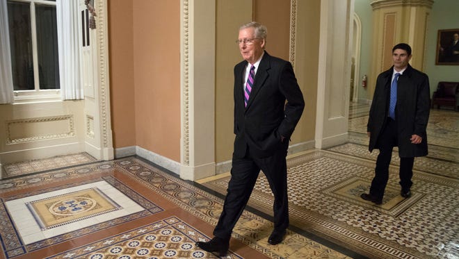 Senate Majority Leader Mitch McConnell walks to his office from the Senate floor on Jan. 11, 2017.
