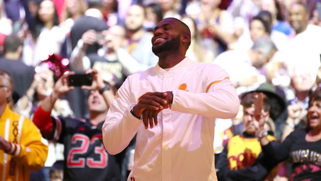LeBron James #23 celebrates with Cleveland Cavaliers' fans  as the team gets its championship rings.