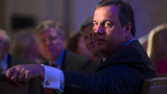 N.J. Gov. Chris Christie listens as he is announced before speaking to the Northern Virginia Technology Council (NVTC) in Tyson's Corner, Va., Friday, May 1, 2015. (AP Photo/Cliff Owen)