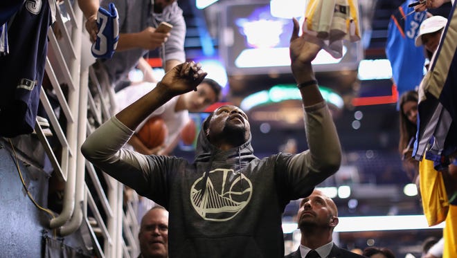 Kevin Durant signs autographs for fans before a game against the Phoenix Suns.