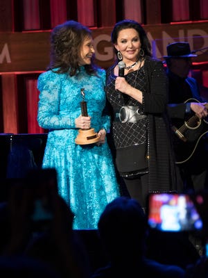 Sisters Loretta Lynn and Crystal Gayle as Gayle was inducted into the Grand Ole Opry.