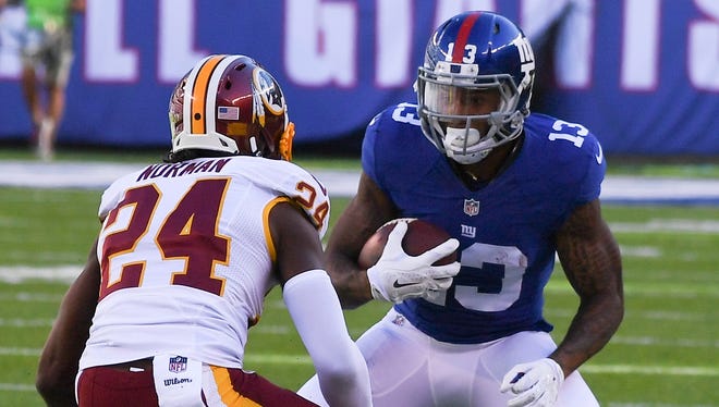 Giants receiver Odell Beckham (13) tries to make a move past Redskins cornerback Josh Norman (24) after a first-half catch.