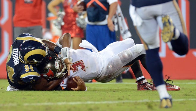 Buccaneers quarterback Jameis Winston (3) gets tackled by Rams defensive end Robert Quinn (94) to end the game.