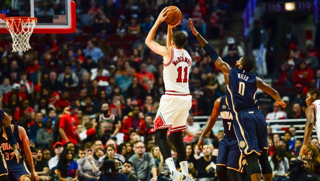Doug McDermott shoots as C.J. Miles defends during the second half at United Center.