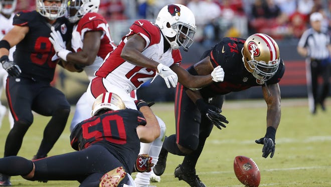 Cardinals wide receiver John Brown (12) fumbles the ball while tackled by 49ers linebacker Nick Bellore (50) and inside linebacker Gerald Hodges (51) during the second quarter at Levi's Stadium in Santa Clara, Calif. on October 6, 2016. The Cardinals recovered.