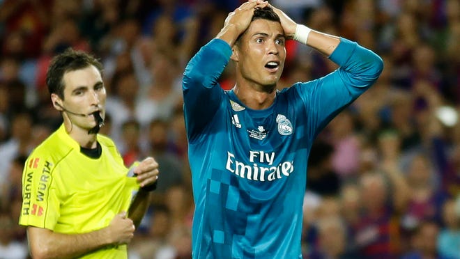 Real Madrid's Cristiano Ronaldo, right, reacts after Referee Ricardo de Burgos shows a second yellow card during the Spanish Supercup, first leg, soccer match between FC Barcelona and Real Madrid at the Camp Nou stadium in Barcelona, Spain, Sunday, Aug. 13, 2017. Cristiano Ronaldo was banned for five games on Monday after shoving a referee following his red card for diving in Real Madrid's 3-1 win over Barcelona in the season-opening Spanish Super Cup. (AP Photo/Manu Fernandez)