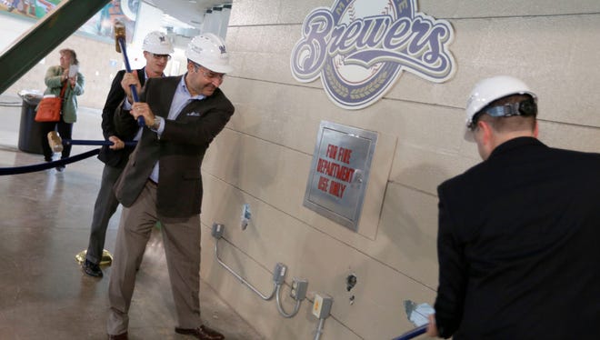 A ceremonial wall demolition took place on an old concession stand on the third base side in what will be the new third base ward. Taking part were Brewers Chief Operating Officer Rick Schlesinger (from left); John Sergi, the co-owner of Howard and Sergi, a hospitality design consultant; and Ken Gaber, general manager with food services Delaware North.