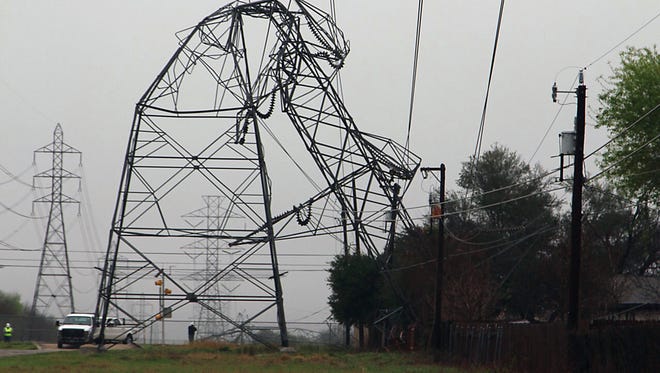 A CPS Energy transmission tower is bent in half on Feb. 20, 2017 in San Antonio. Severe storms pushed at least two tornadoes through parts of San Antonio overnight, ripping the roofs off homes and damaging dozens of other houses and apartments, but causing only minor injuries, authorities said Monday.