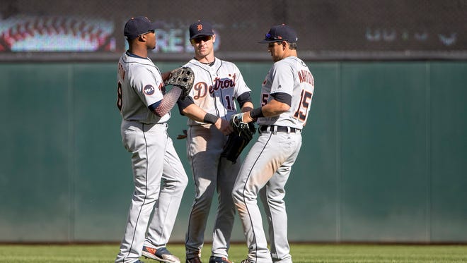 Tigers leftfielder Justin Upton (8), centerfielder Andrew Romine (17) and rightfielder Mikie Mahtook (15) celebrate the Tigers' 5-4 win over the Twins  on Saturday, April 22, 2017 in Minneapolis.