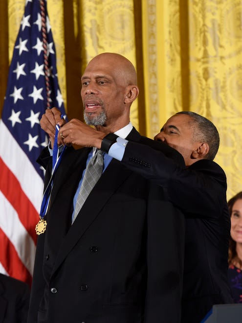 President Obama presents the Presidential Medal of Freedom, the nation's highest civilian honor, to Kareem Abdul-Jabbar during a ceremony in the East Room of the White House.