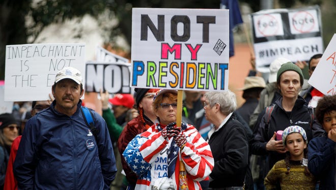 Hundreds of protesters hold signs opposing President  Trump during the 'Not My Presidents Day' rally in Los Angeles.