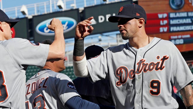Tigers third baseman Nick Castellanos, right, goes through the celebration line after the Tigers' 5-4 win Saturday in Minneapolis.