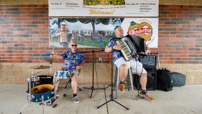 Steve Brunton (left) and Grant Kozera of the Brewhaus Polka Kings perform during the Waukesha Neighborhood Beer Gardens event in Rivers Crossing Park on Thursday, August 17, 2017.